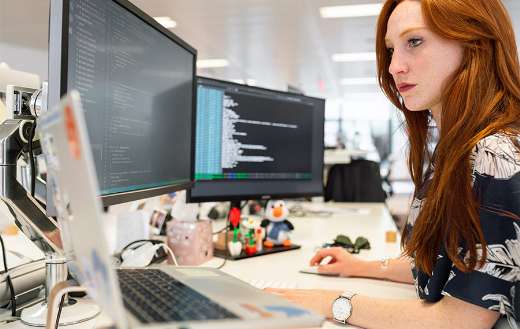 Woman coding on computer puzzle