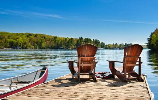 Muskoka chairs on a wooden dock