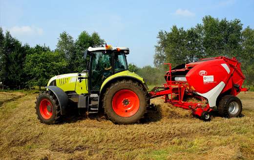 Harvesting tractor on field