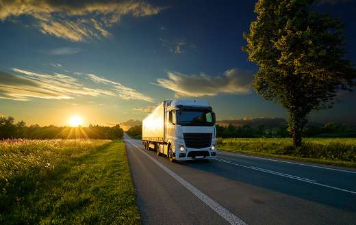 Truck driving in rural landscape