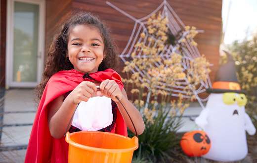 Girl collecting candy for trick or treat
