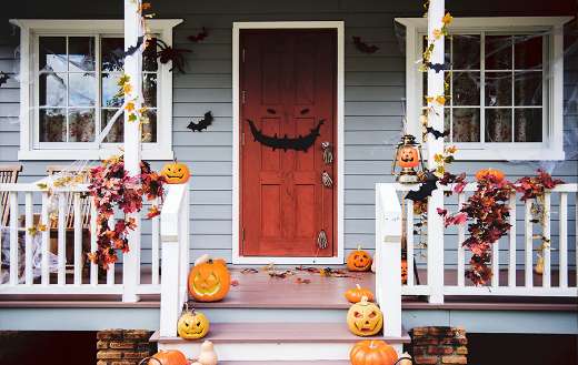 Halloween pumpkins and decorations outside house