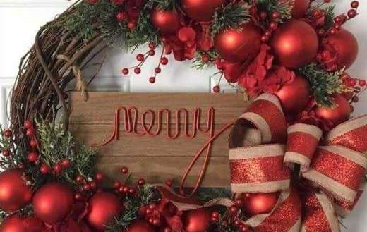 Christmas wreath made of branches red berries bow and ornaments